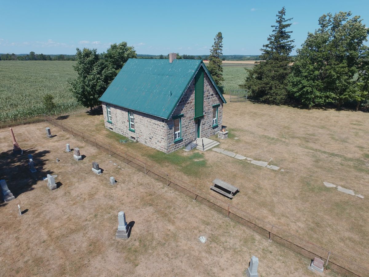 Blue sky, old brick building with a green roof